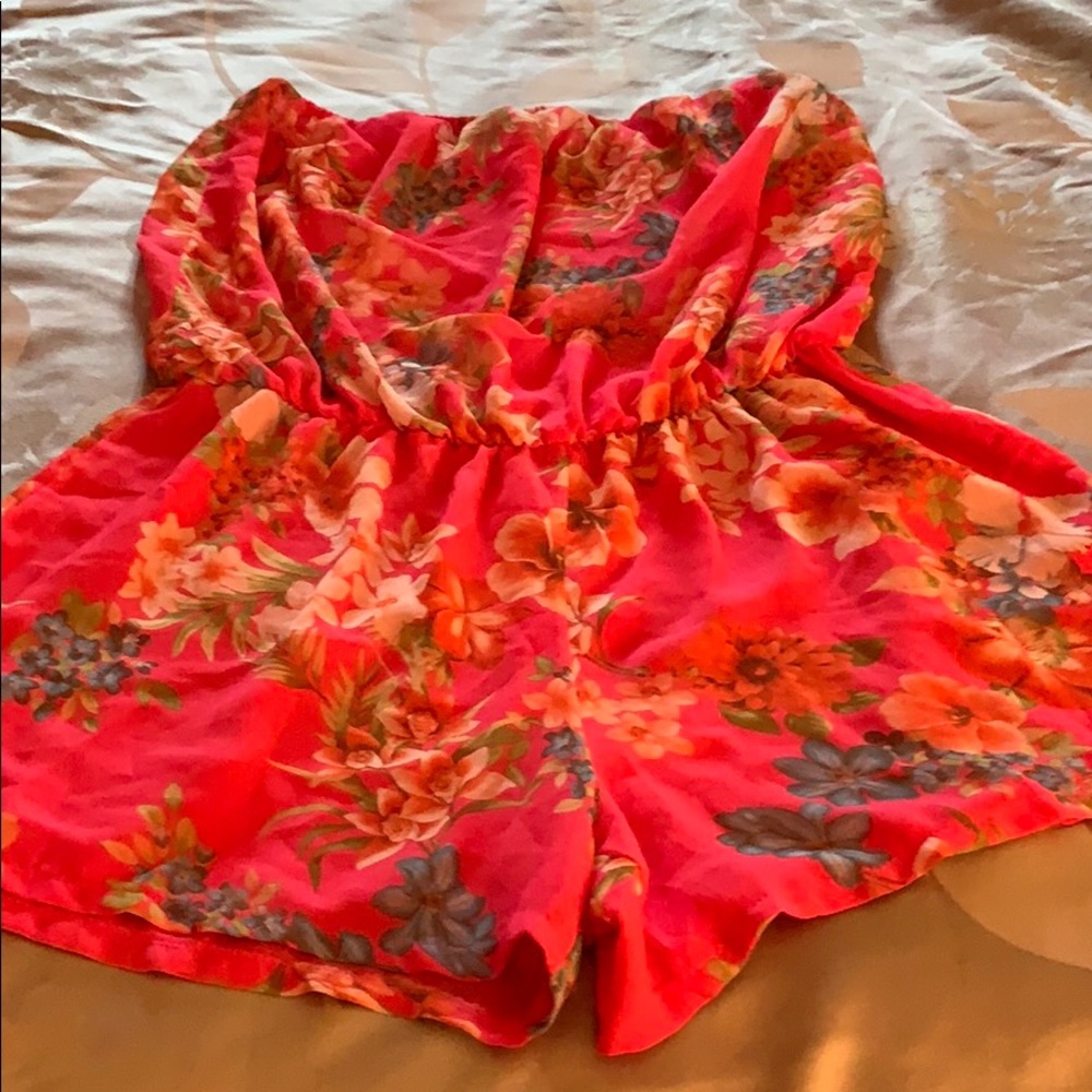 Gently worn pink w/ flower pattern romper